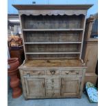 An early 19th century pine dresser with boarded rack, width 141cm, depth 49cm, height 206cm