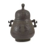 A Chinese bronze jar and cover, hu, 17th/18th century,cast in low relief with taotie masks and