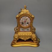 A 19th century gilt metal mantel clock on plinth with key and pendulum 30cm