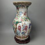 A 19th century Chinese famille rose vase on wooden stand,37 cms high including stand.