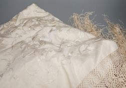 A Chinese cream on cream silk, embroidered shawl with a tasselled fringed edge,160 cms wide x 160