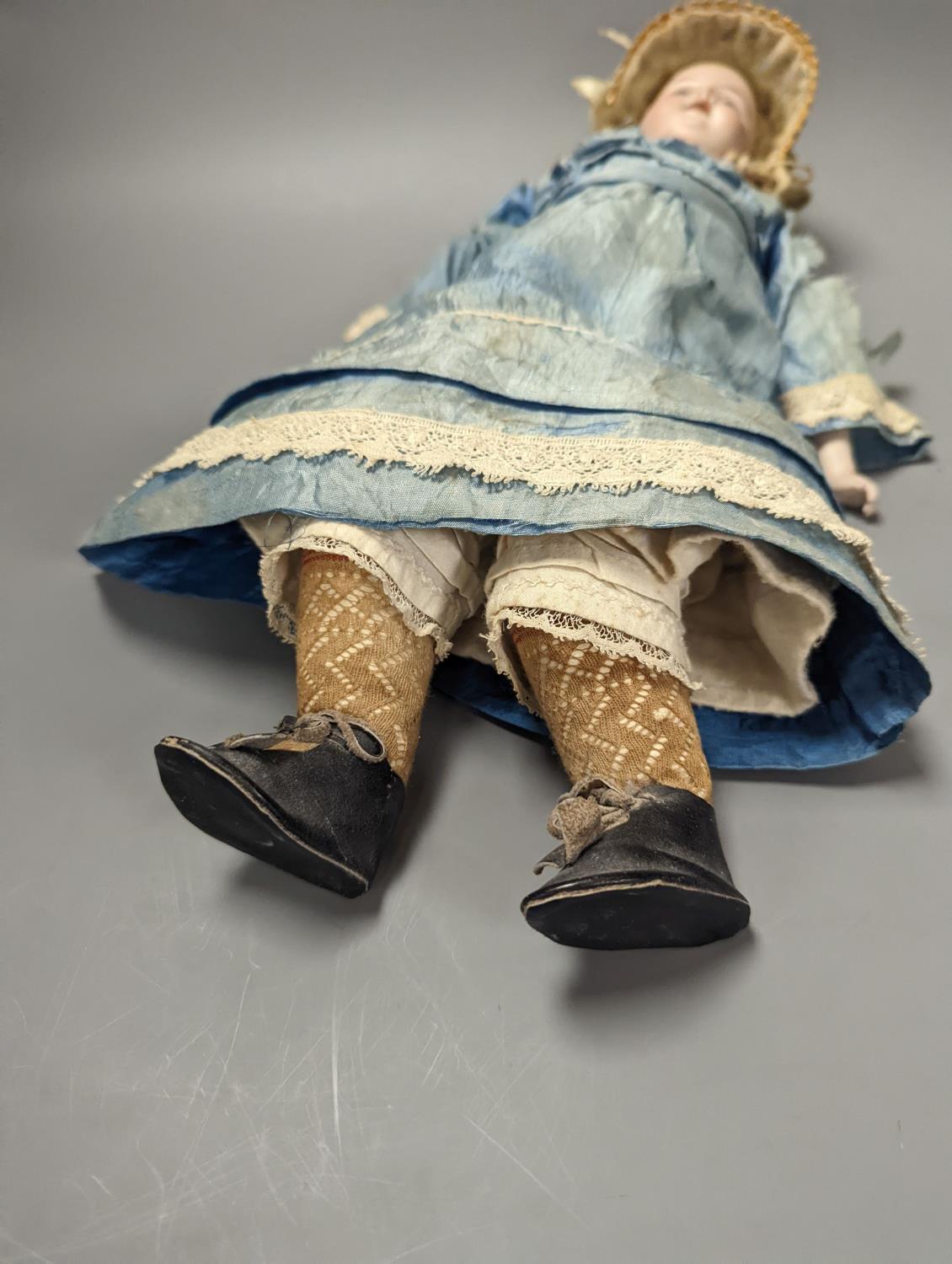 A German bisque headed doll, wearing a blue silk dress and straw bonnet, 42 cms high. - Image 5 of 5
