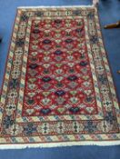 A Caucasian style red ground rug, 210 x 140cm