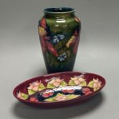 A Moorcroft orchid pattern green glazed vase, signed William Moorcroft to underside and a similar