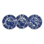 A set of three Chinese blue and white ‘pheasant’ large plates, Kangxi period,each painted with