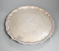 A George III silver salver, with gadrooned border, on three shell feet, Ebenezer Coker, London,