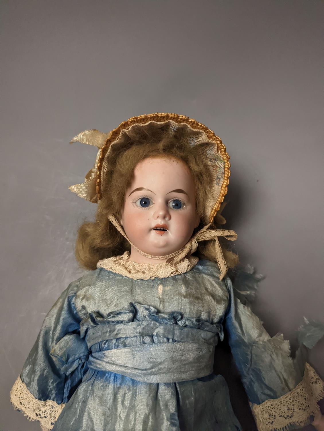 A German bisque headed doll, wearing a blue silk dress and straw bonnet, 42 cms high. - Image 2 of 5