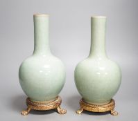 A pair of Chinese celadon crackle glazed bottle vases with gilt metal stands total height 27cm,