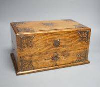 A Victorian oak smoker's box, with brass mounting,30 cms wide x 17 cms high.