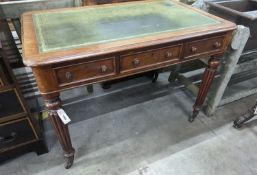 A Victorian mahogany three drawer writing table on fluted legs, width 106cm, depth 66cm, height