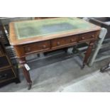 A Victorian mahogany three drawer writing table on fluted legs, width 106cm, depth 66cm, height