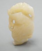 A Chinese bowenite jade carving of a boy with a branch,5.5 cms high.