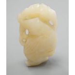 A Chinese bowenite jade carving of a boy with a branch,5.5 cms high.