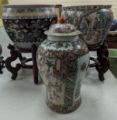 A pair of Chinese fish bowls on hardwood stands and a similar jar and cover,Fish bowls and stands 54