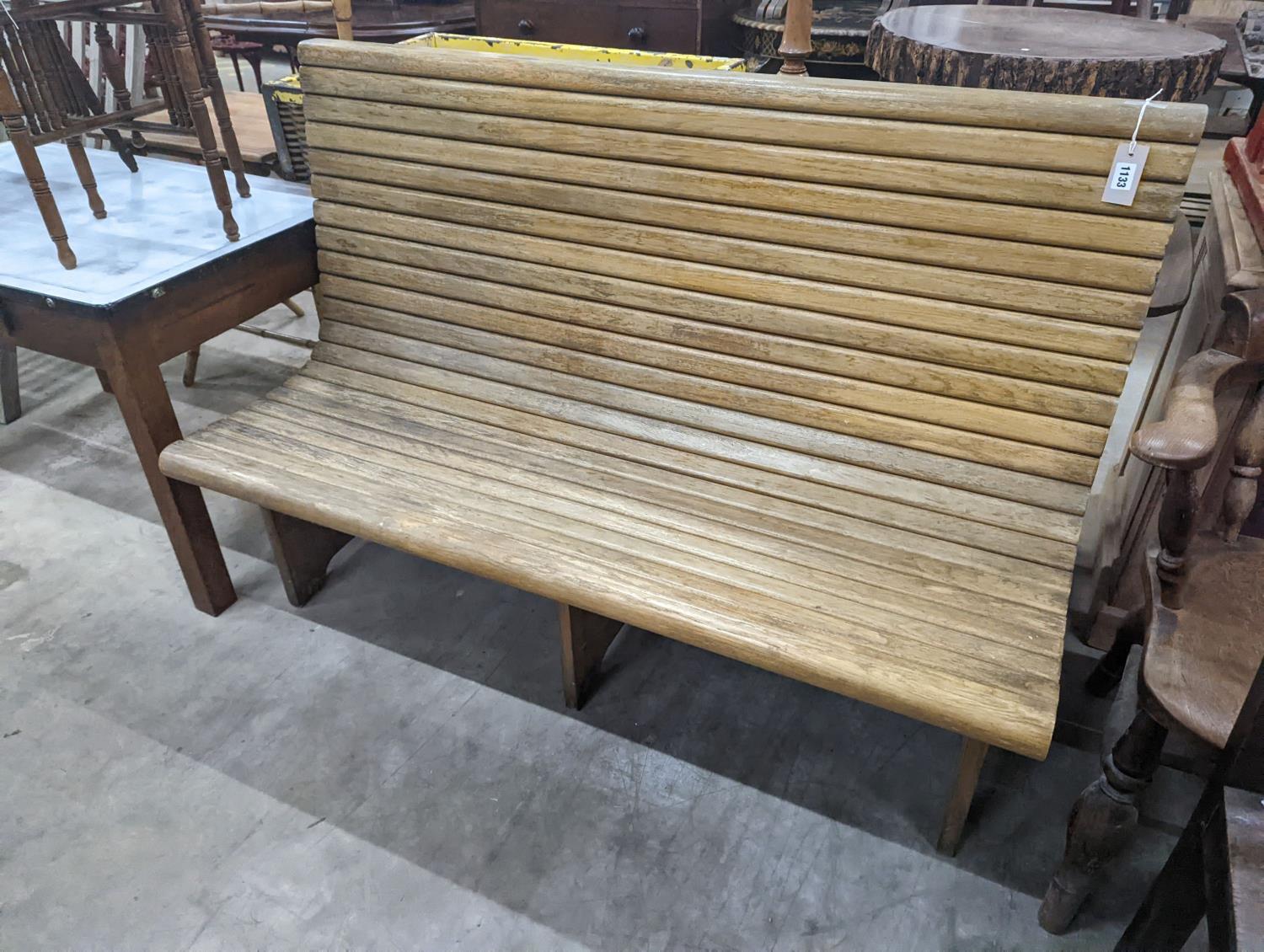 A vintage slatted wood tram bench, length 140cm, depth 60cm, height 98cm