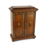A late 19th century gilt metal mounted walnut games cabinet,with two panelled doors enclosing