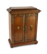 A late 19th century gilt metal mounted walnut games cabinet,with two panelled doors enclosing