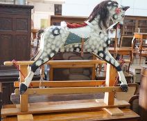 A vintage Ayres type dapple grey carved wood rocking horse on beech safety frame, length 130cm,