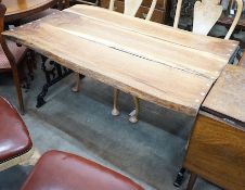 A Victorian style cast metal garden table with waney edged oak plank top, length 122cm, depth