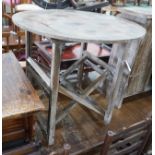 A French provincial pine circular table on folding underframe, diameter 77cm, height 72cm