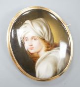 A yellow metal mounted porcelain miniature oval brooch, painted with a young boy, 64mm, gross weight