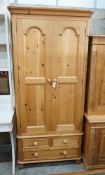 A modern narrow pine wardrobe, the base fitted with three drawers, width 92cm, depth 59cm, height
