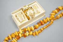 An amber bead necklace, gross 72 grams and a costume bracelet and earclips.