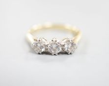 A modern 18ct gold and three stone diamond set ring, size J, gross weight 3 grams.