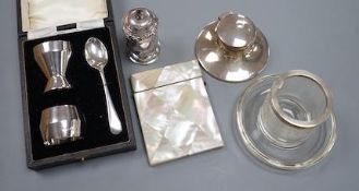 A 1930's cased silver christening trio, a silver mounted inkwell, a silver pepperette, a silver