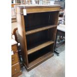 An Edwardian oak open bookcase, length 78cm, width 25cm, height 122cm