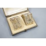 A late Victorian cased pair of pierced silver triangular napkin rings, by Goldsmiths &