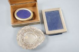 A silver mounted cigarette box, a silver bonbon dish and two photo graph frames including silver.