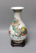 A Chinese famille verte pear shaped ‘Buddhist lion’ vase, on stand, 32 cms high not including