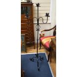 A wrought iron tripod pricket candle stand, height 140cm