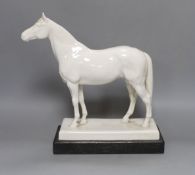 A Meissen model of a horse ‘Alchimist’ signed Erich Oehme 1935, on wooden stand 30cm, crossed swords