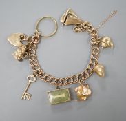 A 1960's 9ct gold charm bracelet, hung with eight assorted mainly 9ct gold charms and a 22ct gold