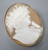 A yellow metal mounted oval cameo shell brooch, carved with the bust of a lady to sinister, 47mm,