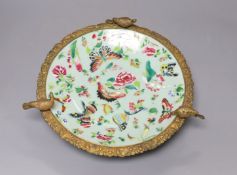 A 19th century Chinese famille rose dish with ormolu mount,29 cms diameter.