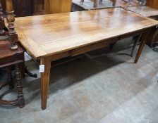 An early 19th century French rectangular fruitwood kitchen table fitted two drawers, length 201cm,