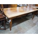 An early 19th century French rectangular fruitwood kitchen table fitted two drawers, length 201cm,