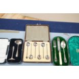 Three assorted silver cased sets, including coffee spoons, christening trio and spoon and pusher.