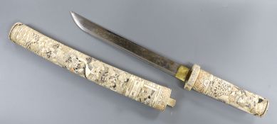 A Japanese carved and coloured ivory tanto, Meiji period, the hilt and scabbard carved to both sides