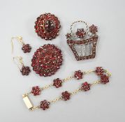 A Victorian gilt metal and facetted garnet set cluster brooch, 27mm, two other similar brooches, a