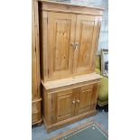 A modern pine dresser, enclosed by two pairs of fielded panelled doors, length 96cm, depth 45cm,