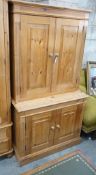 A modern pine dresser, enclosed by two pairs of fielded panelled doors, length 96cm, depth 45cm,