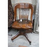 An early 20th century American walnut swivel desk chair by the Marble and Shattuck Chair Company,