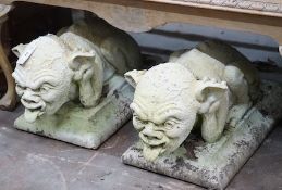 A pair of stone gargoyle garden ornaments, length 60cm, depth 30cm, height 32cm