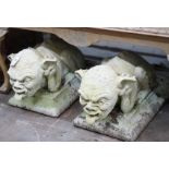 A pair of stone gargoyle garden ornaments, length 60cm, depth 30cm, height 32cm