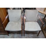 A pair of mid century teak upholstered elbow chairs, width 54cm, depth 63cm, height 84cm