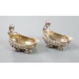 A pair of late 19th/early 20th century Hanau white metal salts, modelled as boat's with wheels and